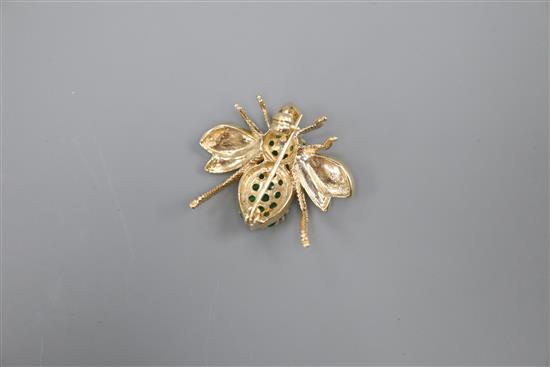 A modern 14k yellow metal, emerald cluster and diamond set bee brooch, width 3cm, gross 8.4 grams.